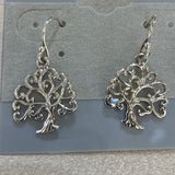 Silver trees with curved branches dangle from curved earwires.