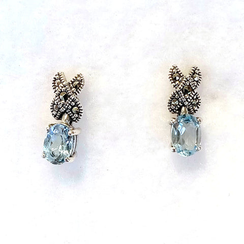 marcasite earrings X shape post stud with a prong set oval faceted blue topaz stone hanging down