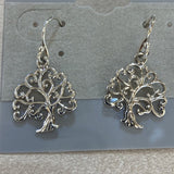 Silver trees with curved branches dangle from curved earwires.