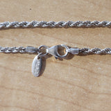 close up of lobster claw clasp, endcaps, and "M.S.J" quality tag, "925" quality marks