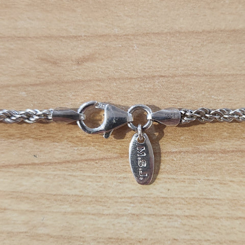 close up of lobster claw clasp, endcaps, and "M.S.J" quality tag, "925" quality marks