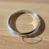 high polish hinging bangle with safety domed outside and flat inside