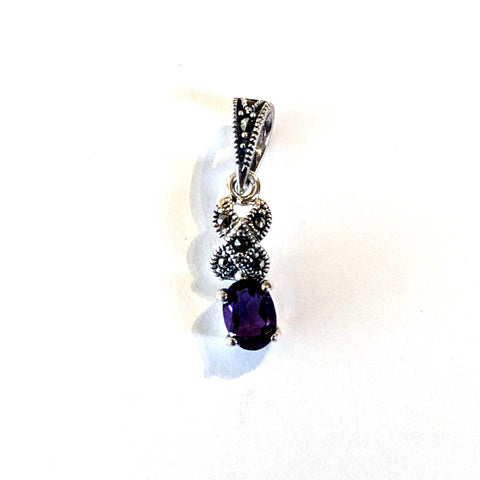 small silver and marcasite pendant with oval amethyst prong set
